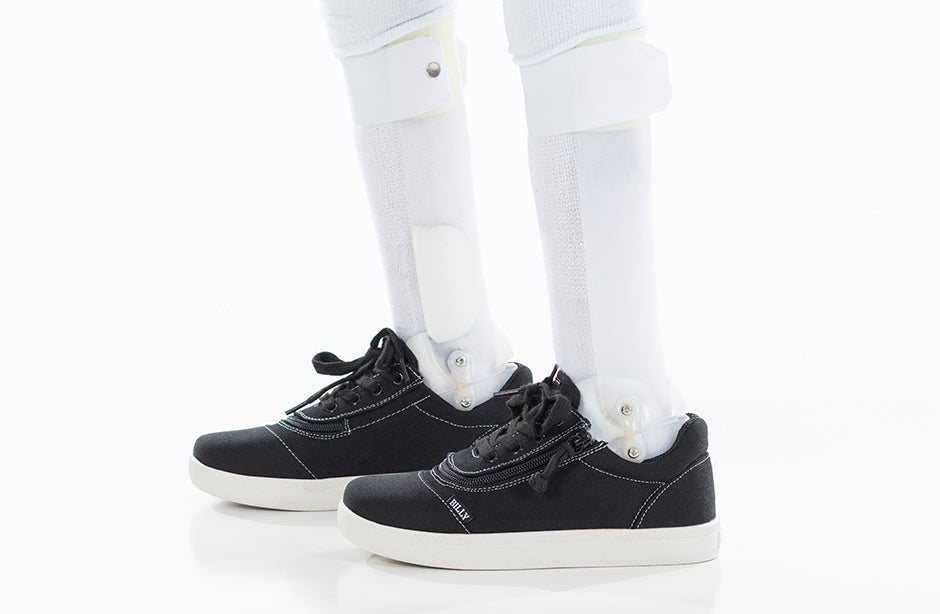 Black/White BILLY D|R Short Wrap Low Tops feature adjustable laces and a wrap zipper for easy wear, suitable for diverse foot widths.