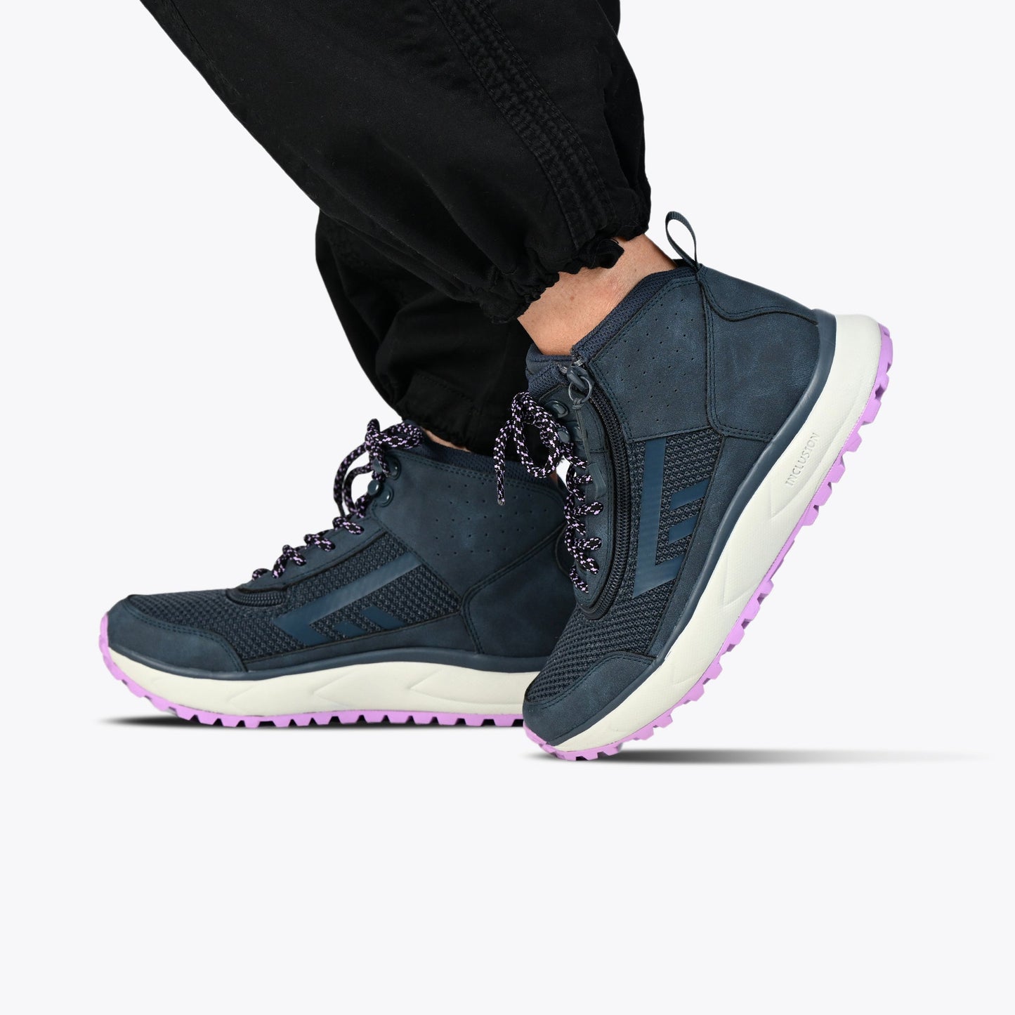 Women's Navy/Purple BILLY Inclusion Trail Boot with easy-entry zipper, padded collar, and comfortable insole, showcased on a person wearing black pants.