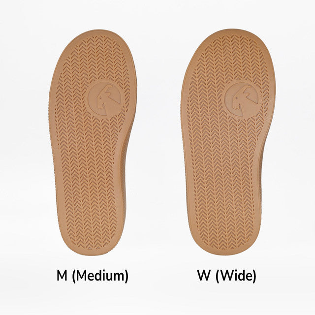 Close-up of textured brown soles from Billy Footwear's Toddler Black/Gum CS Canvas Shoes, featuring functional laces and a wraparound zipper for accessibility.